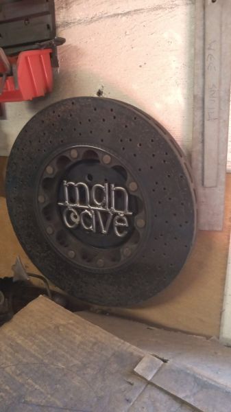 Ferrari ceramic brake disc, transformed into a unique Man Cave sign: Swipe To View More Images