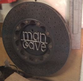 Ferrari ceramic brake disc, transformed into a unique Man Cave sign: Click Here To View Larger Image